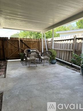 Seminole house for rent - A patio with a table and chairs under a roof.
