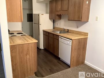 Knoxville apartment for rent - A kitchen with wooden cabinets and a white refrigerator.