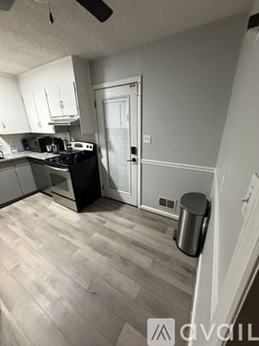 Smyrna house for rent - A room with a ceiling fan and wooden flooring.