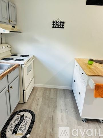 Sorrento apartment for rent - A kitchen with a white stove and white cabinets.