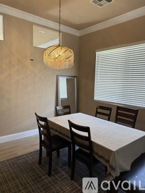 Henderson house for rent - A spacious room with wooden floors and a staircase on the right side.