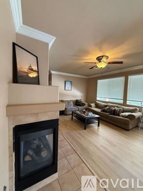 Henderson house for rent - A room with a fan, carpet, and a window.