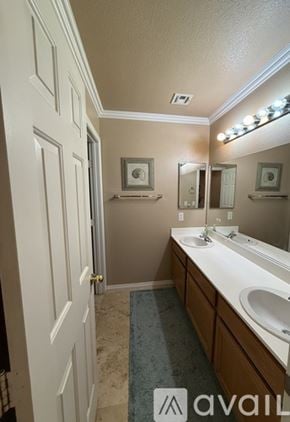 Henderson house for rent - A bathroom with a tub, sink, and mirror.
