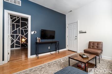 Chicago apartment for rent - A living room with a brown leather chair and a flat screen TV.