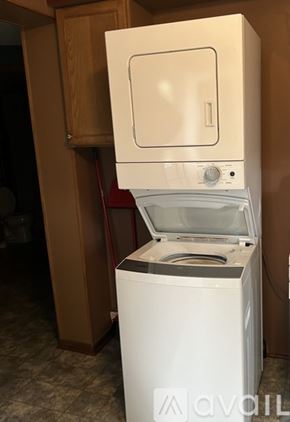 Bemidji house for rent - A bedroom with a bed, dresser, and window.