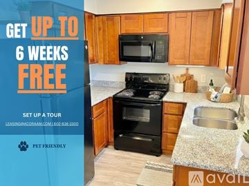Phoenix apartment for rent - A kitchen with a refrigerator, microwave, and oven is on display for a move-in special.
