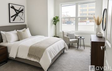 Philadelphia apartment for rent - A kitchen with white cabinets and a black fridge.