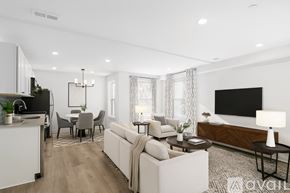 Philadelphia apartment for rent - A spacious living room with wooden flooring and white walls.