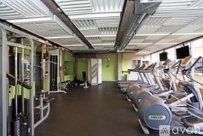 Philadelphia apartment for rent - A gym with a row of treadmills and a row of dumbbells.