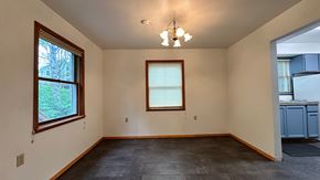 Sitka house for rent - A room with a window and a chandelier.
