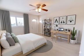 Edmonton apartment for rent - A bathroom with a toilet, sink, and mirror.