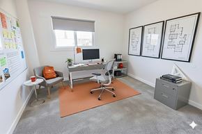 Edmonton apartment for rent - A modern building with a peach facade and a white fence.