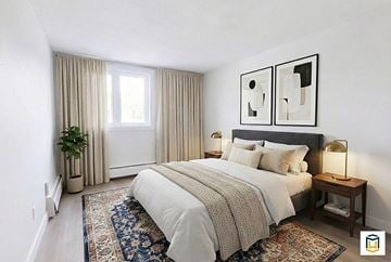 Edmonton apartment for rent - A bedroom with a large bed and two framed pictures on the wall.