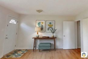 Edmonton apartment for rent - A spacious basement with a staircase, a white refrigerator, and a blue cabinet.