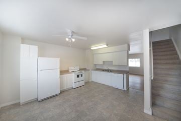 Edmonton apartment for rent - A white kitchen with a refrigerator, stove, and oven.