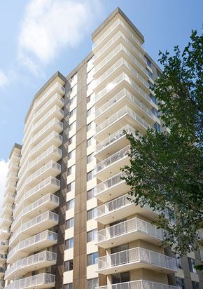 Edmonton apartment for rent - A tall building with balconies on each floor.
