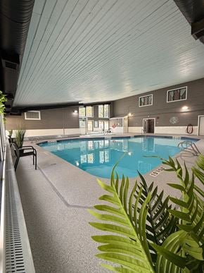 Edmonton apartment for rent - A building with a sign that says "Lavalle Foods" is surrounded by trees and bushes.