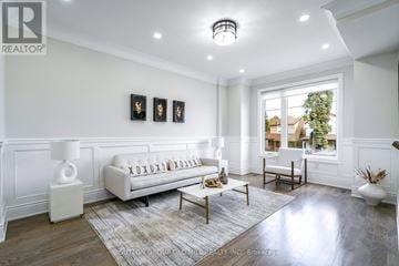 Toronto (Birchcliffe-Cliffside) house for rent - A well-lit, spacious living room with a white sofa and a large window.