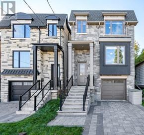 Toronto (Birchcliffe-Cliffside) house for rent - A house with a stone facade and a black garage door.