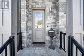 Toronto (Birchcliffe-Cliffside) house for rent - A stone wall with a door and a number 70 on it.