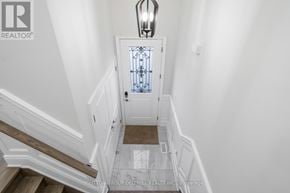 Toronto (Birchcliffe-Cliffside) house for rent - A white door with a glass window is at the end of a hallway.