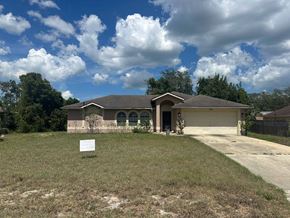 Deltona house for rent - A house with a sign in front of it.