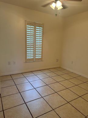 Deltona house for rent - A room with a window and a ceiling fan.