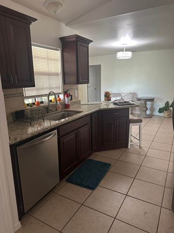 Deltona house for rent - A kitchen with brown cabinets and a tiled floor.