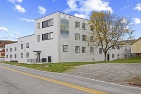 Altoona apartment for rent - A white building with a yellow line in front of it.