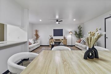 Altoona apartment for rent - A modern living room with a wooden table and white furniture.