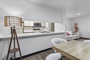 Altoona apartment for rent - A modern dining room with a wooden table and white chairs.