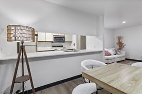 Altoona apartment for rent - A modern dining room with a wooden table and white chairs.