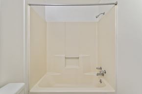 Altoona apartment for rent - A white bathroom with a toilet and a bathtub.