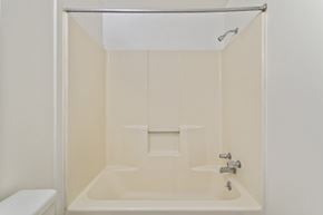 Altoona apartment for rent - A white bathroom with a toilet and a bathtub.