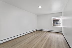 Altoona apartment for rent - A room with wooden flooring and white walls.
