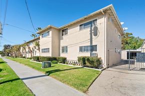 Burbank apartment for rent - A residential building with a green lawn in front.