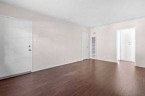 Burbank apartment for rent - A room with white walls and brown floors.