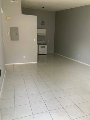 Pensacola house for rent - A kitchen with white tile flooring and a white oven.