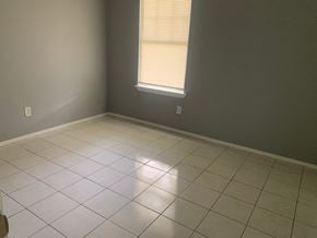 Pensacola house for rent - A room with a window and tiled floor.
