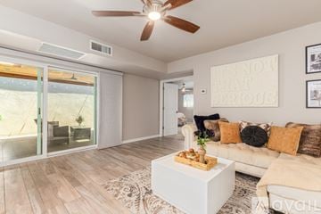 Scottsdale house for rent - A living room with a white couch and a wooden coffee table.