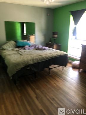 North Little Rock house for rent - A bedroom with a bed, nightstand, and lamp.
