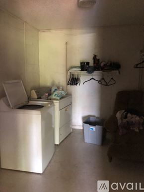 North Little Rock house for rent - A small laundry room with a washer and dryer.