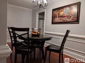 Atlanta townhouse for rent - A dining room with a table set for two and a painting on the wall.