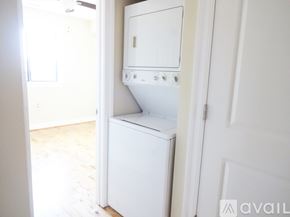 Washington apartment for rent - A white dishwasher is sitting in a narrow hallway.