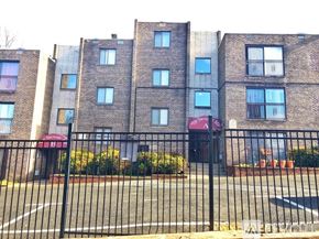 Washington apartment for rent - A brick building with a black fence in front.