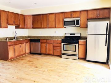 Washington apartment for rent - A kitchen with wooden cabinets and a white fridge.