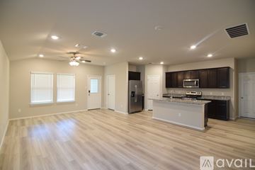 Temple house for rent - A spacious kitchen with a refrigerator, sink, and stove is available for rent.
