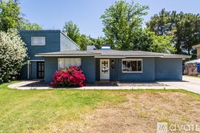 Mesa apartment for rent - A house with a blue exterior and a red flower in front.