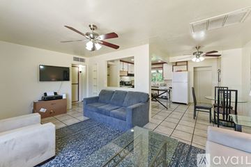 Mesa apartment for rent - A living room with a blue couch and a television.