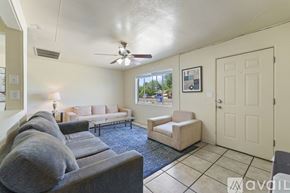 Mesa apartment for rent - A living room with a grey couch and a fan on the ceiling.